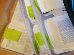 Pile of printed journal articles for reading
